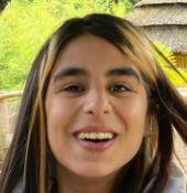 - 1,60 m
- Tenger postuur
- Neuspiercing
- Zwart topje, lichtblauwe joggingsbroek, slippers en groene rugtas
